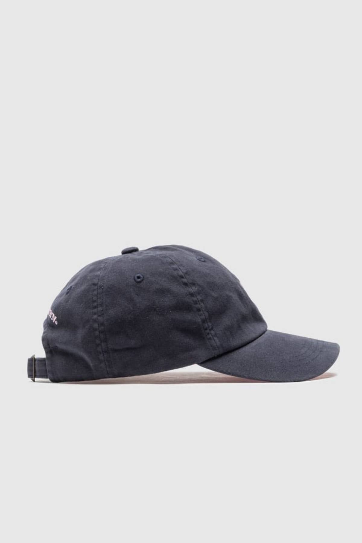 The Rodd & Gunn Gunn Cap Petite, a classic black cotton twill cap with a curved brim and adjustable back strap, is displayed from the side against a light gray background.