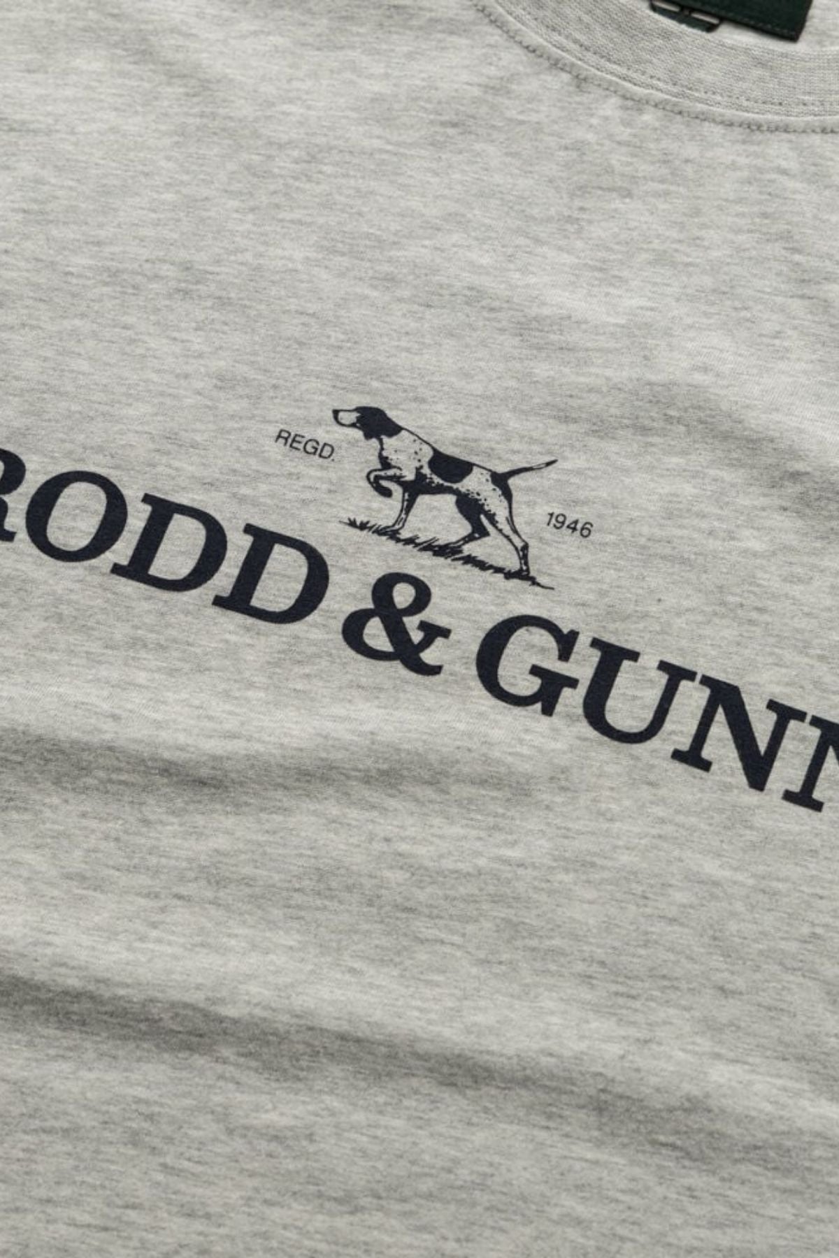 A close-up of the Rodd & Gunn The Logo Tee 2.0, a menβs cotton sports fit t-shirt, with a black outline of a hunting dog above "RODD & GUNN" and "REGD 1946" near the graphic.