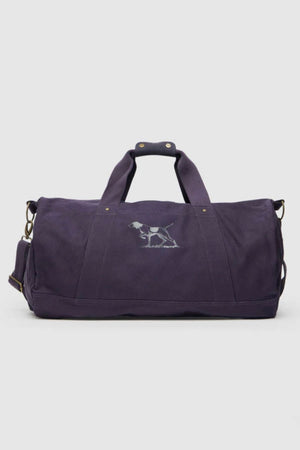 The Rodd & Gunn Ponsonby Road Duffle Bag is a purple cotton canvas bag with two handles, a shoulder strap, and an embroidered dog outline on the front.