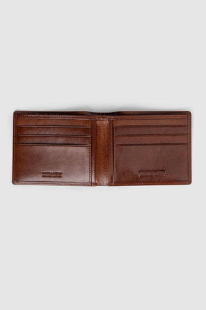 The Rodd & Gunn Wakefield Bi-Fold Wallet, crafted from open brown Italian leather, features multiple card slots on both sides. Shown empty on a plain grey background from a top-down view.