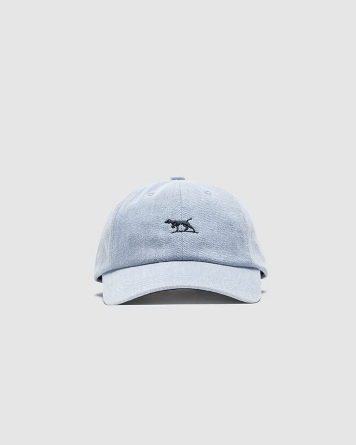 The Rodd & Gunn Gunn Cap is a light blue baseball cap made from heavy-duty cotton twill, featuring a small black embroidered dog on the front and shown against a plain light gray background.