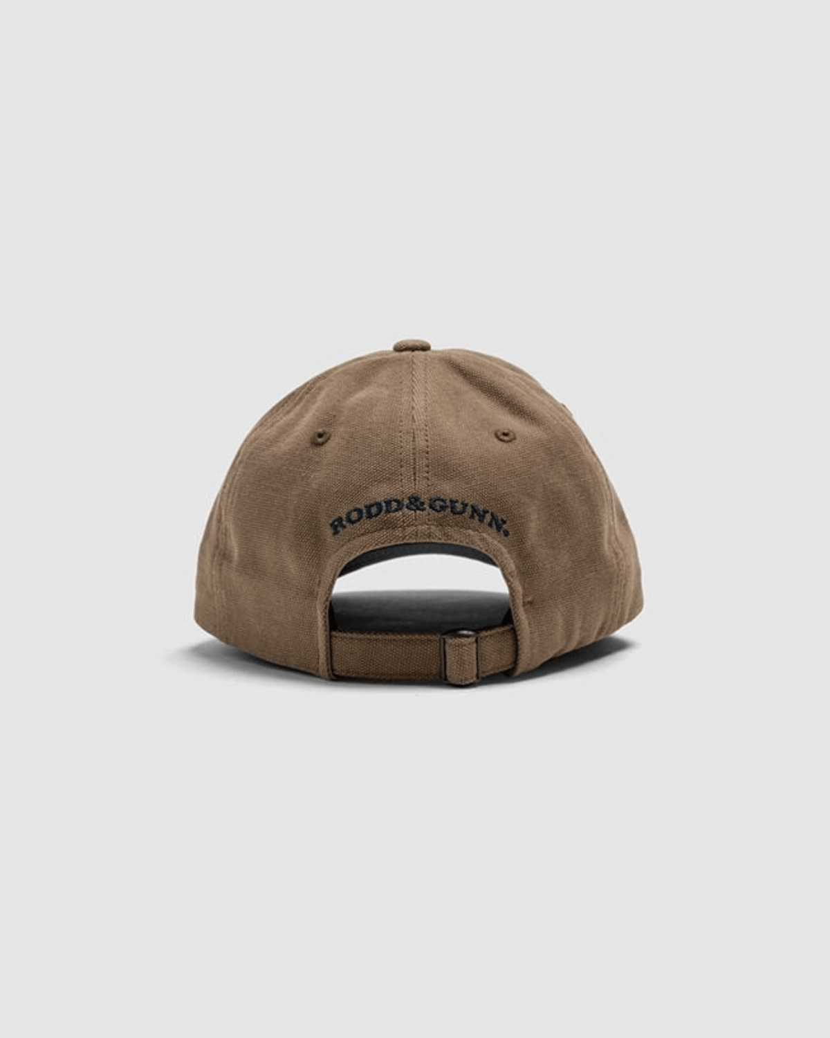 The Rodd & Gunn Signature Cap is a brown cotton twill cap shown from the back, featuring an adjustable strap and "RODD & GUNN" embroidered above the opening.