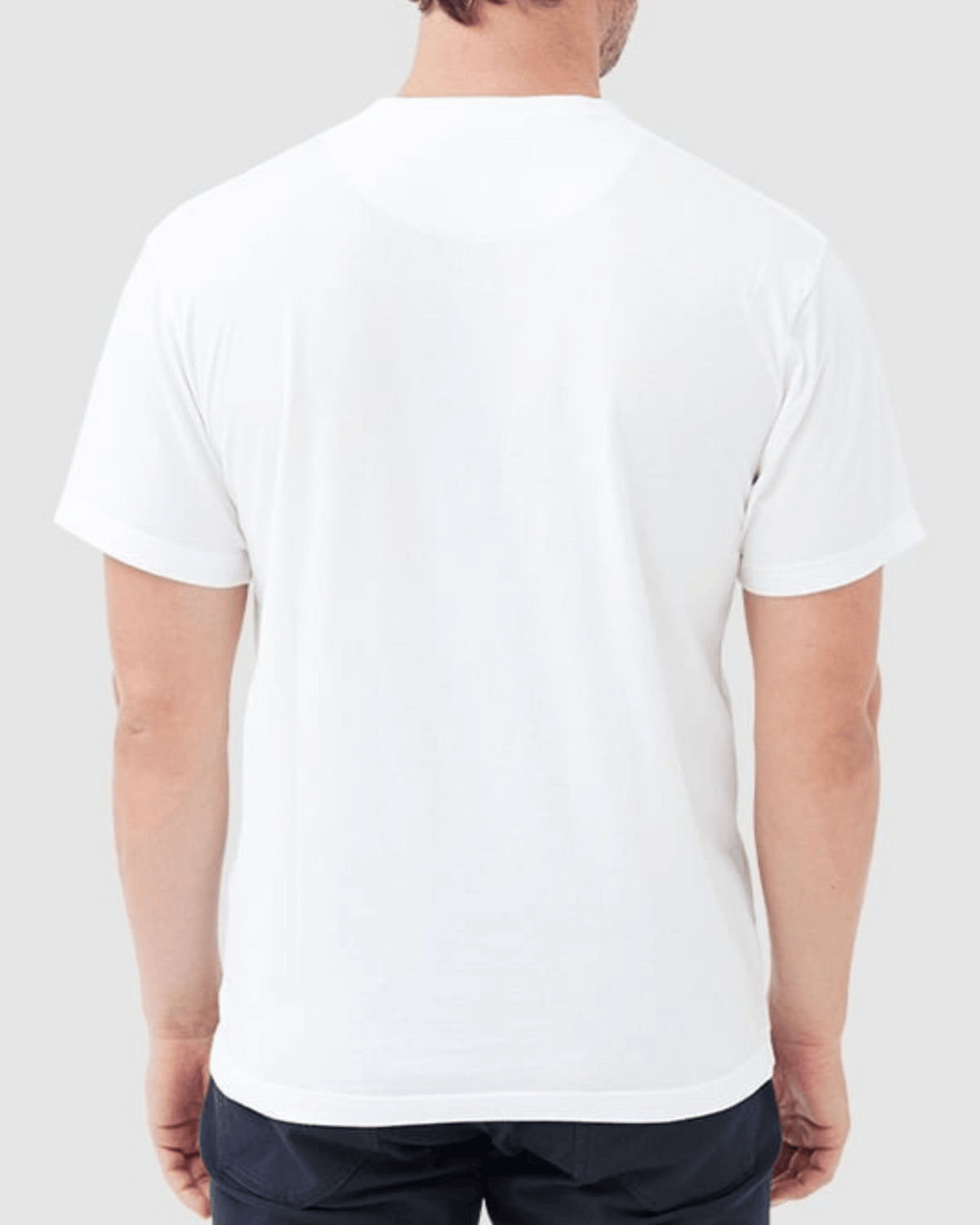 The image features the back view of a person wearing the "Rodd & Gunn The Gunn T-Shirt," made from Australian Cotton in plain white, paired with dark pants in a sports fit. The background is light gray.