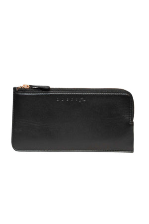The Rusty Trafalgar Leather Wallet is a black full grain leather zippered pouch with a simple rectangular design, card compartments inside, and small embossed letters on the front. The zipper runs along the top edge.