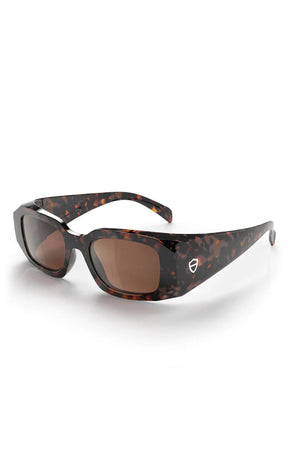 SafeStyle Auras feature a brown tort rectangular frame with marbled dark brown and amber design, brown polarised lenses, and a white shield logo on the temple. UV400 protection ensures your eyes stay safe from harmful rays.