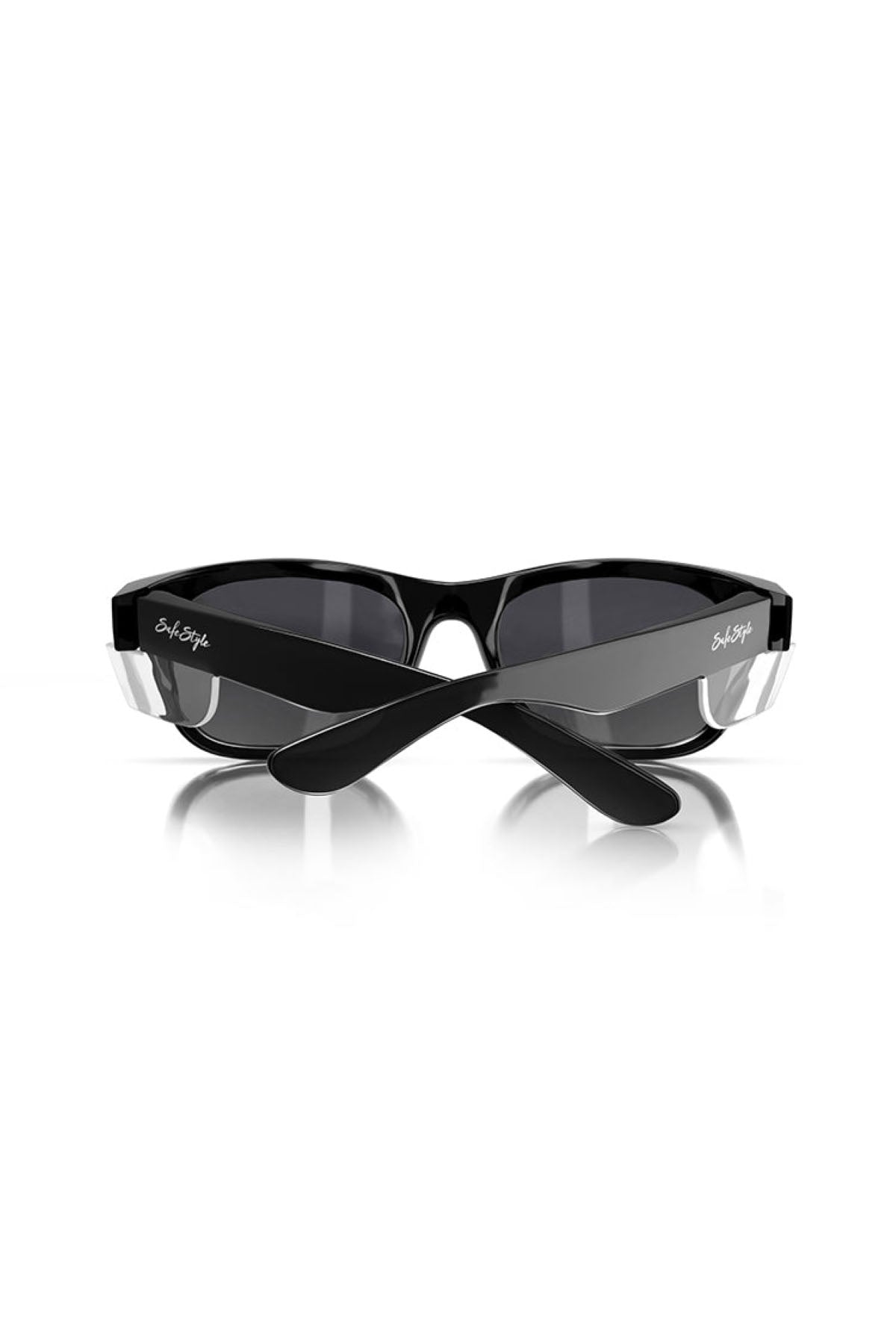 A pair of SafeStyle Classics Black Frame Tinted Lens sunglasses featuring a sleek design, dark tinted lenses, and black arms with transparent hinge accents. The folded sunglasses show the arms crossed over each other, revealing white signature text on the temples against a plain white background.