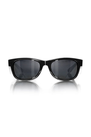 A pair of SafeStyle Classics Black Frame Tinted Lens sunglasses featuring a sleek, rectangular design and dark, tinted lenses. The symmetrical glasses are set against a white background with a slight reflection visible beneath them. These stylish shades also offer excellent UV protection.