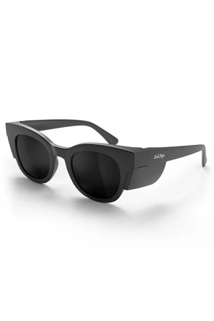 The SafeStyle Harps sunglasses feature a matte black chunky cat-eye frame with polarised dark lenses for UV protection. The brand logo appears on the arm, displayed against a white background.