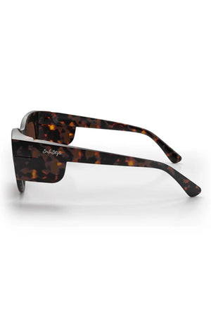 Side view of SafeStyle Harps Matte Tort sunglasses with thick, shatterproof frames and brown polarised lenses. "SafeStyle" is written in white on the side, offering stylish UV protection for sunny days.