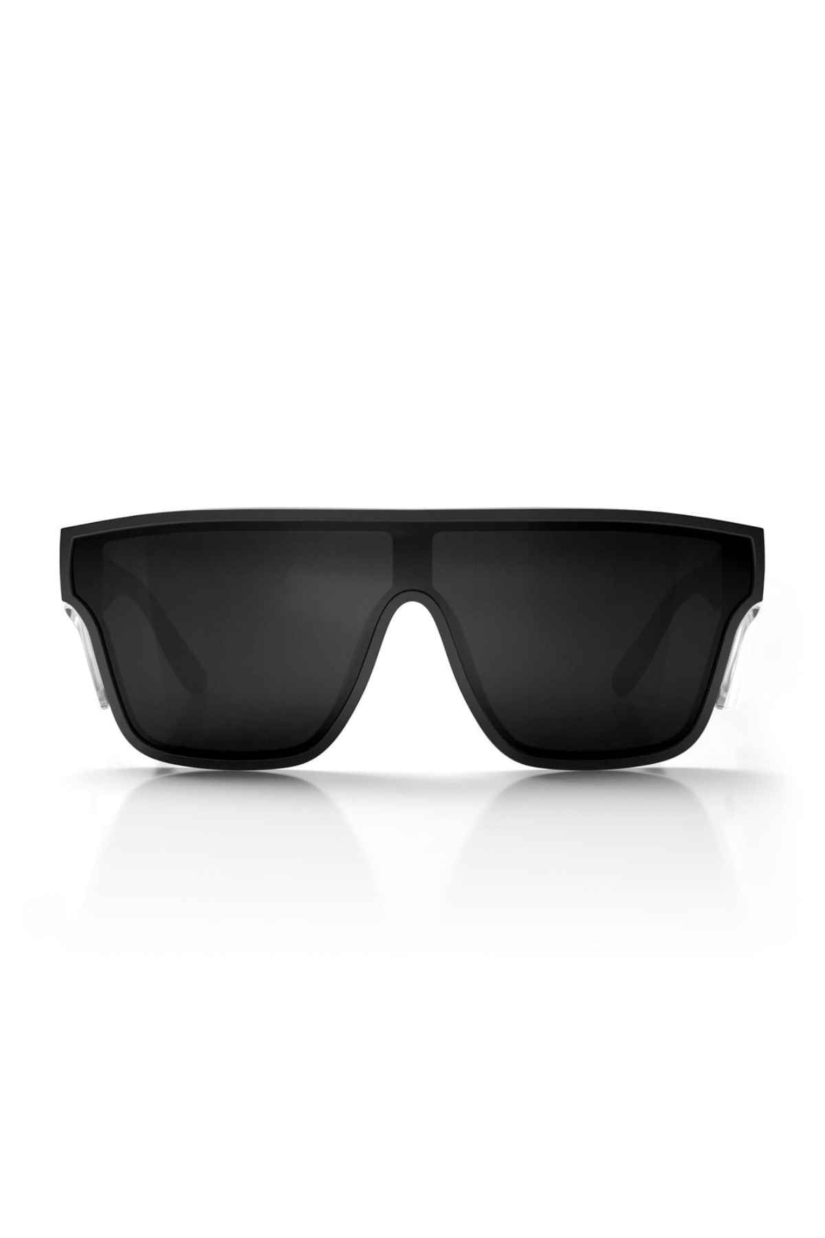 The SafeStyle Primes Black Frame Polarised Lens sunglasses showcase a sleek and modern design with thick frames and dark lenses. Made from shatterproof polycarbonate, they feature a wide front and slightly angular edges. The stylish black sunglasses are displayed against a white background, casting a faint shadow underneath.