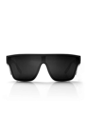 The SafeStyle Primes Black Frame Polarised Lens sunglasses showcase a sleek and modern design with thick frames and dark lenses. Made from shatterproof polycarbonate, they feature a wide front and slightly angular edges. The stylish black sunglasses are displayed against a white background, casting a faint shadow underneath.