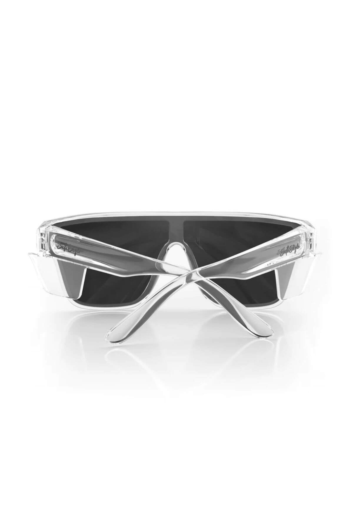 The SafeStyle Primes sunglasses showcase a futuristic design with clear frames and UV400-tinted lenses. The antiscratch coating adds durability, while the arms are crossed in front to highlight the sleek style against a plain white background.