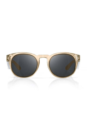 Front view of SafeStyle Cruisers with a champagne frame and tinted polycarbonate lenses offering UV400 protection, resting on a white surface with a subtle reflection below.