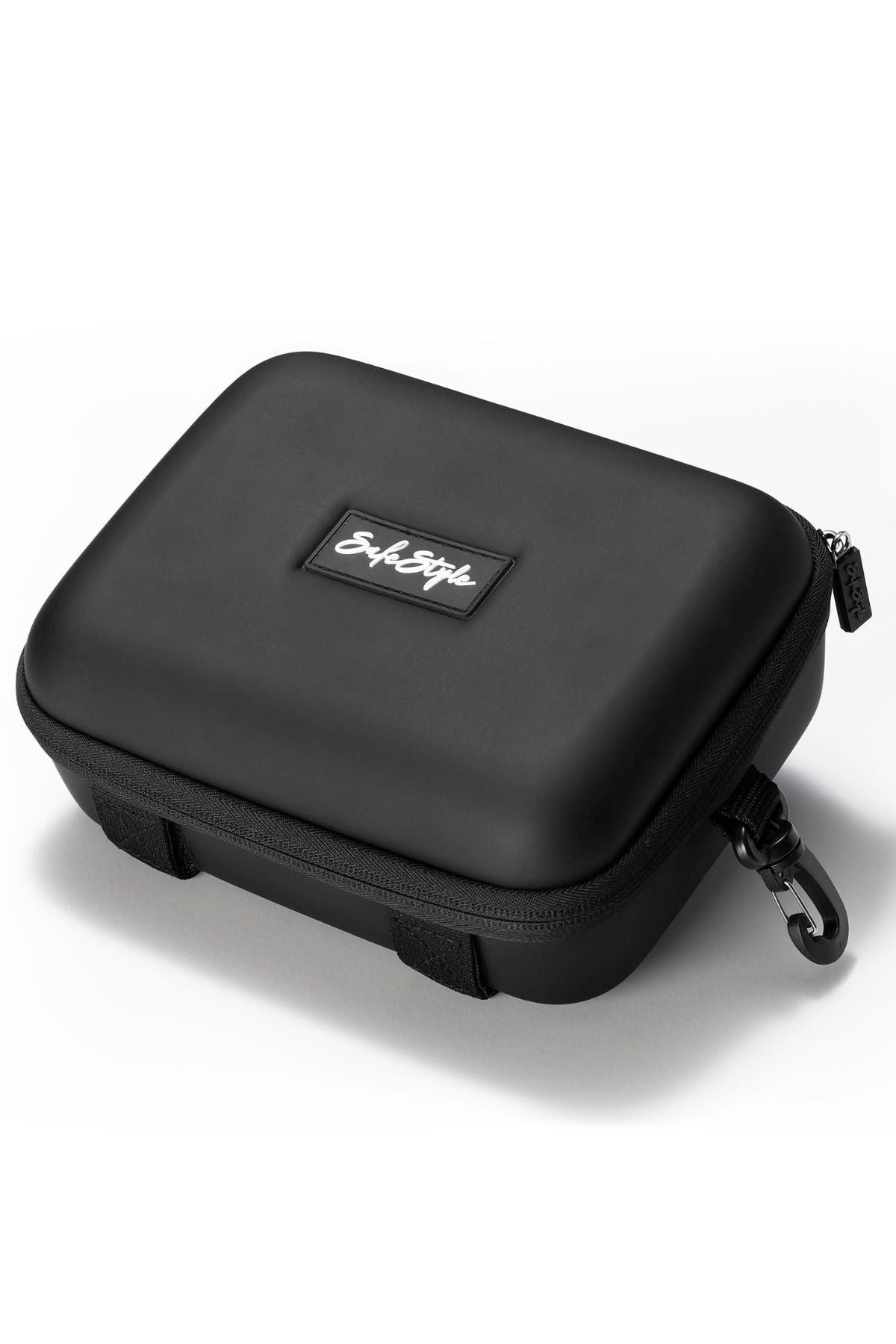 The Safestyle Double Hardcase is a black, rectangular EVA storage case for safety glasses with a zipper, side clip, and top patch displaying the Script logo. It's shown resting on a white surface.