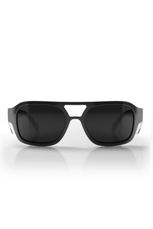 Safestyle Skylines sunglasses feature a vintage-inspired black rectangular frame with grey polarised lenses, white arm accents, a cut-out bridge, and UV400 protection, shown on a white reflective surface.
