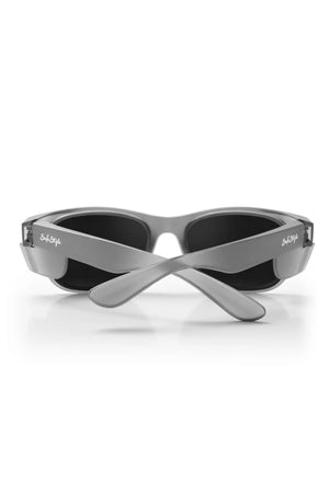 The Safestyle Classics Matte Graphite Frame Polarised Lens sunglasses are shown from the back with crossed arms and subtle white logos, featuring black polarised lenses and UV400 protection—ideal stylish eyewear against a white background.