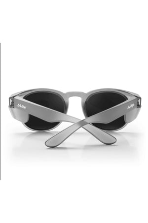 The Safestyle Cruisers Matte Graphite Frame Polarised Lens sunglasses are shown from the back with crossed temples. The "Salt Life" logo appears near the hinges. These stylish sunglasses offer UV protection and are set against a white background.