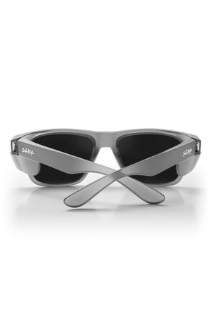 The Safestyle Fusions sunglasses feature a matte graphite frame and polarised black lenses, shown from the back with crossed arms and a subtle logo on the temples for stylish, protective eyewear.