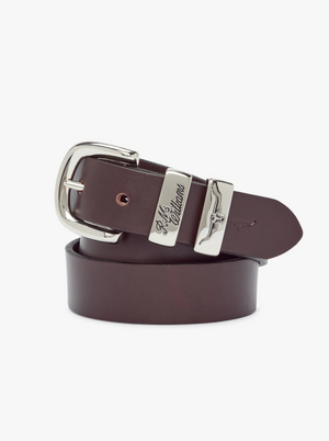 The RM Williams Slim Drover Belt, made in Australia from solid dark brown leather, features a silver buckle and two signature engraved loops. It’s coiled neatly on a white background.