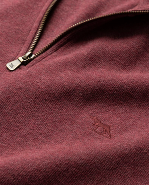 Close-up of the Rodd & Gunn Alton Ave Sweat in maroon, highlighting a quarter zip with a metal zipper. Made from 100% cotton, it features an embroidered animal logo that subtly decorates the texture.