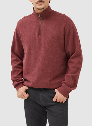 A person stands with hands in pockets, wearing dark pants and the maroon Rodd & Gunn Alton Ave Sweat, a 100% cotton quarter-zip pullover featuring a subtle logo on the left chest, set against an off-white backdrop.