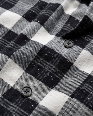 Close-up of the Rodd & Gunn Halfmoon Ave Shirt, a comfortable 100% cotton checkered flannel with two black buttons. The soft, textured fabric displays detailed stitching and subtle color variation in the pattern.