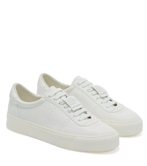 The Superga 4834 Club S sneakers feature a minimalist design with grape-based faux leather, laces, and a smooth upper. They sit on a chunky vulcanized rubber sole, with the brand tag angled slightly to the right on the tongue.