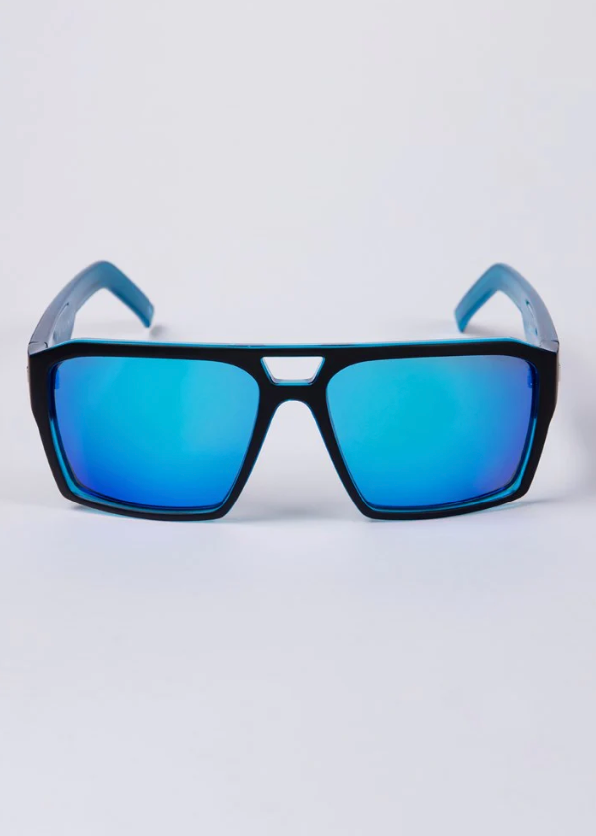The UNIT Vault Polarised Eyewear sunglasses, with a black frame and blue mirrored lenses, are showcased against a white background. These stylish sunglasses highlight their reflective finish and polarised lenses, ensuring superior UV protection for your eyes.