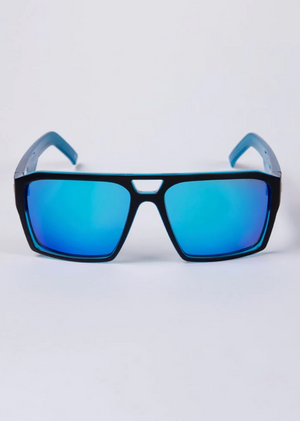 The UNIT Vault Polarised Eyewear sunglasses, with a black frame and blue mirrored lenses, are showcased against a white background. These stylish sunglasses highlight their reflective finish and polarised lenses, ensuring superior UV protection for your eyes.