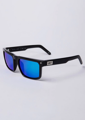 UNIT Primer Polarised Eyewear features black sunglasses with blue-tinted, polarised lenses. The lightweight, glossy frame showcases "UNIT" branding in white and offers UV protection. They rest on a white surface, displaying both the front and side views.