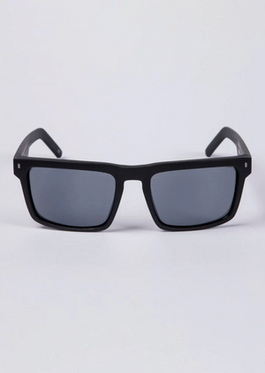 The UNIT Primer Polarised Eyewear features black rectangular frames with lightweight construction and dark UV-protective polarised lenses, shown facing forward against a plain white background.