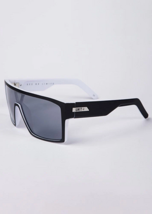 UNIT Command Polarised Eyewear features rectangular black frames, gray lenses, and white lightweight arms. The left arm displays a metallic "UNIT" tag with a star logo. Provides UV protection. Set against a plain white background.