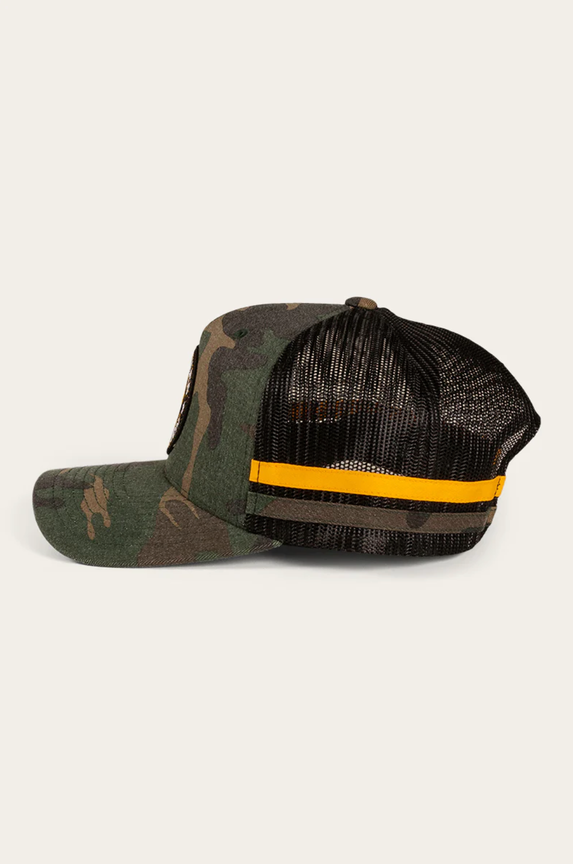 Side view of the Ringers Western McCoy Kids Trucker Cap: camo front with a slightly curved brim, black mesh back, adjustable strap, and yellow horizontal stripe.