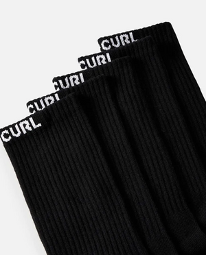 Close-up of Rip Curl Brand Crew Sock 5 Pack, showcasing five black ribbed crew socks, each featuring the word "CURL" in white capital letters at the top. Designed for optimal arch support, these socks are neatly arranged in a row with their tops perfectly aligned against a plain white background.