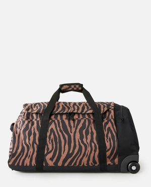 The Rip Curl Jupiter 80L Travel Bag is a large, water-resistant duffle with black and brown zebra stripes, black straps, and two wheels for easy transport. It is shown on a white background.