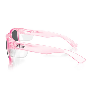 SafeStyle Fusions Pink Frame Polarised Lens sunglasses feature translucent pink polycarbonate frames, UV-protective polarised lenses, and a small breast cancer awareness ribbon with text on the side, shown against a white background.