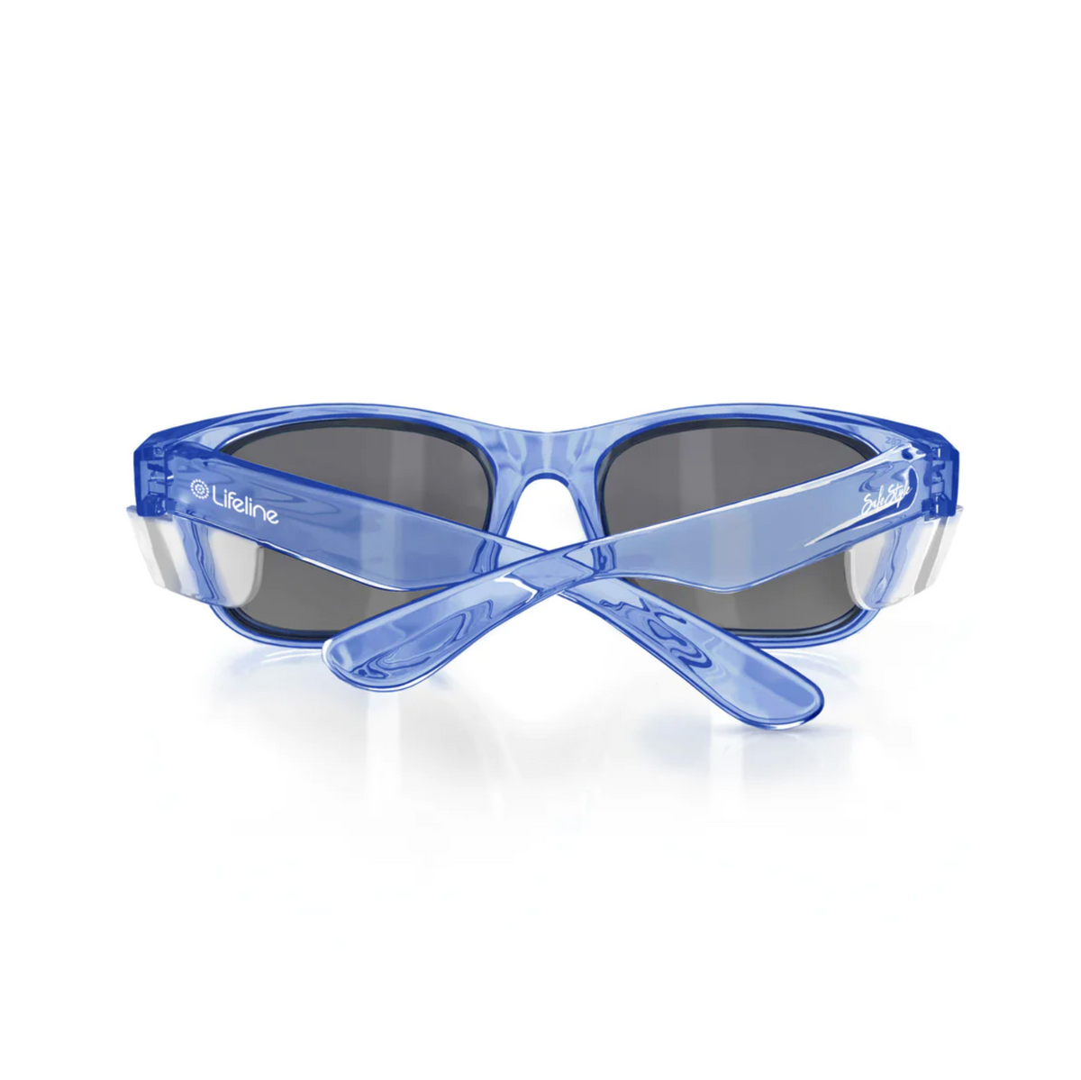 The SafeStyle Classics Blue Frame Tinted Lens safety glasses are shown from the back with crossed arms, displaying their sleek design and tinted lenses for reliable UV protection, while logos on the sides emphasize both style and safety.