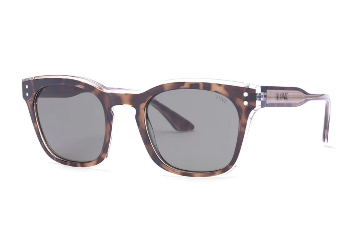 The Liive Morgan Sunglasses boast a rectangular tortoiseshell frame with dark lenses in the classic Wayfarer style, blending brown tones and transparent accents by the hinges, while ensuring essential UV protection.