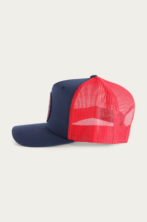 Side view of the Ringers Western Signature Bull Trucker Cap features a navy blue cotton twill front and brim, a vibrant red mesh back, and a circular patch on the front, blending style and comfort effortlessly.