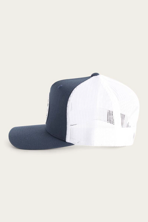 Side view of the Ringers Western Signature Bull Trucker Cap, featuring a dark blue cotton twill front and brim, white mesh back, curved brim, and adjustable rear strap. Set against a plain beige background.
