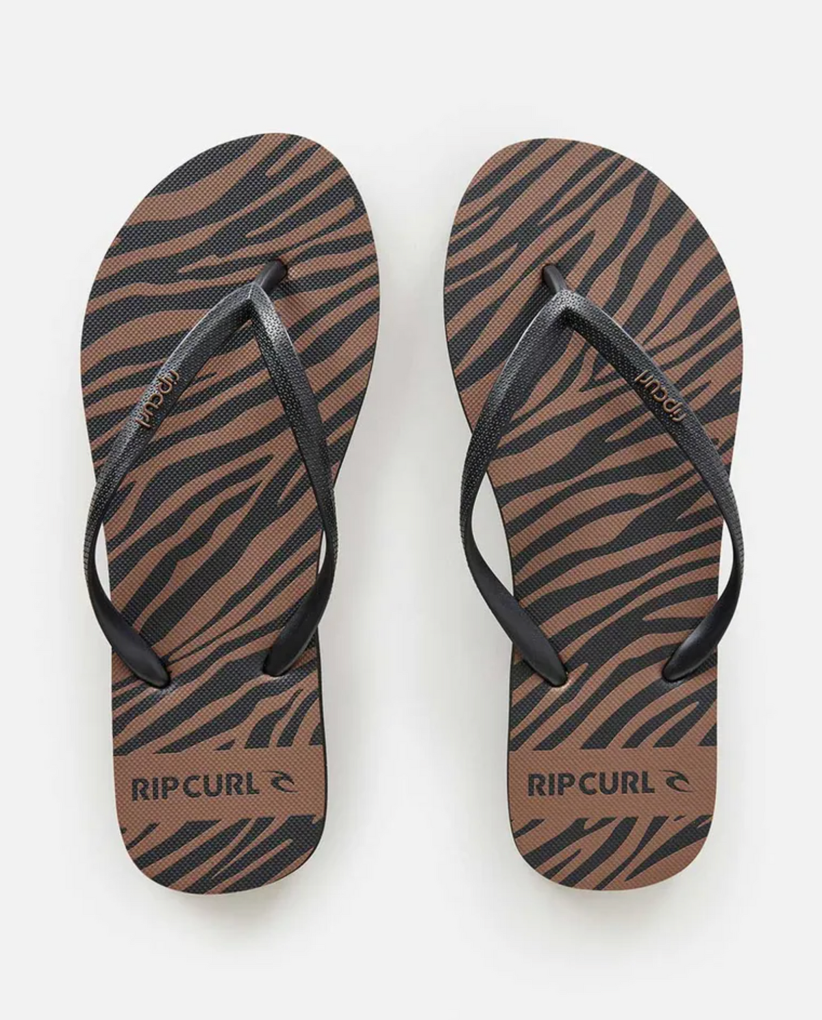 A pair of Rip Curl Sun Tribe Bloom Thongs with ergonomic molded rubber straps and a brown and black zebra stripe EVA rubber footbed, displayed from above on a white background.