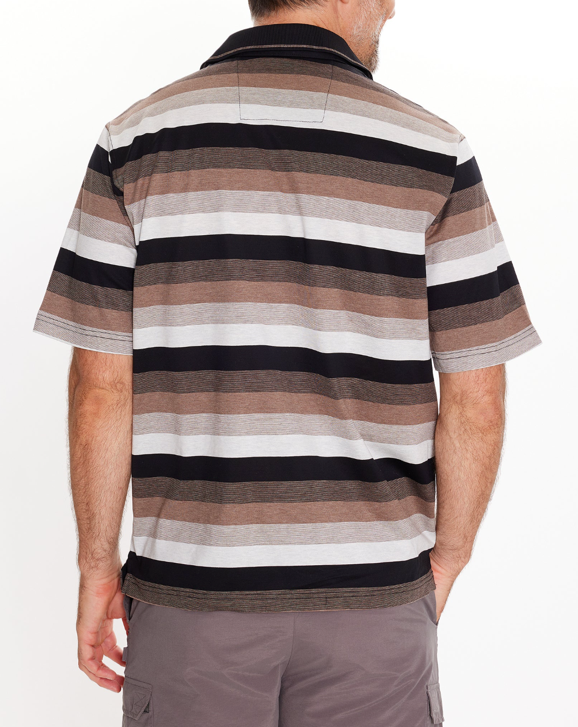 A man stands with his back to the camera, wearing the Breakaway Ked Mercerised Poloโcasual, short-sleeve, with horizontal black, brown, and gray stripesโpaired with gray shorts. His right hand rests in his pocket.
