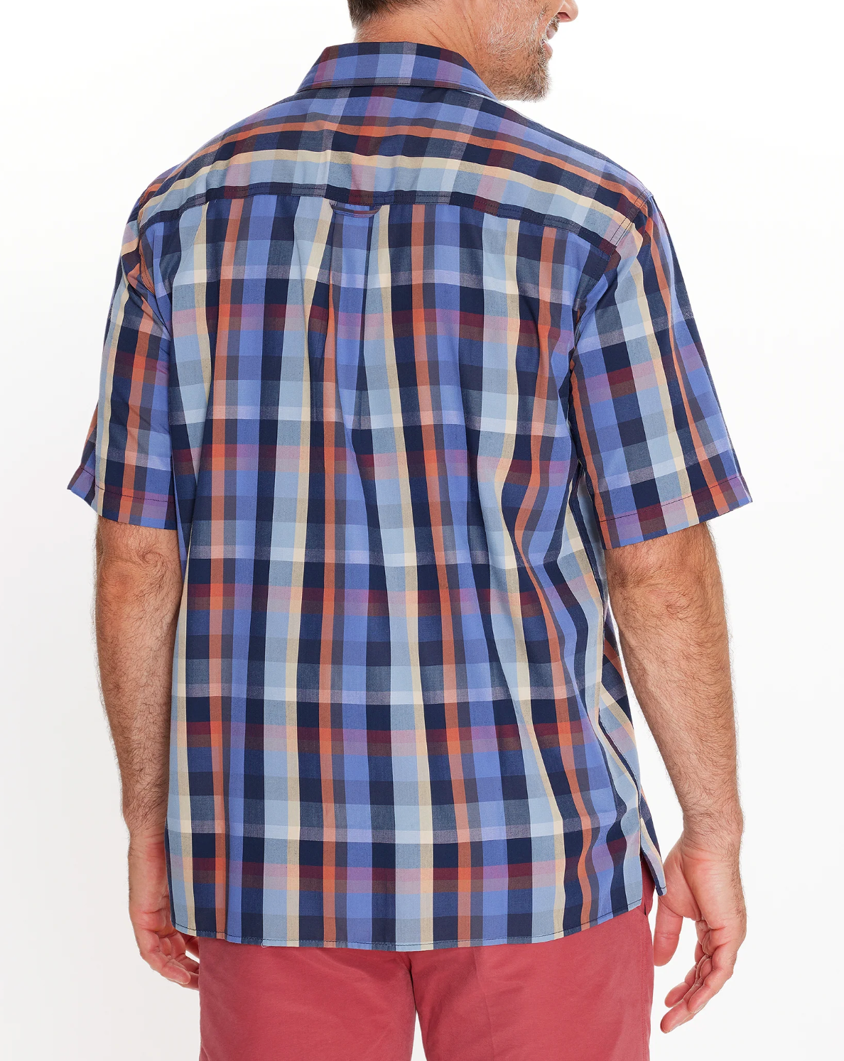 A person wearing a Breakaway Rome Bamboo Blend Shirt, a short-sleeved blue and red plaid casual shirt made from comfortable bamboo polyester, stands with their back to the camera. They're also in red pants against a plain white background.