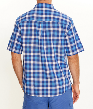 A man is seen from behind wearing the Breakaway Gil Oxford Shirt, a short-sleeve blue and white plaid 100% cotton casual shirt, paired with blue shorts, against a plain white background.