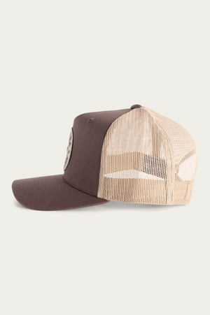 The Ringers Western Signature Bull Trucker Cap in brown and beige features a cotton twill front panel and mesh back, displayed in profile facing left on a plain light background.