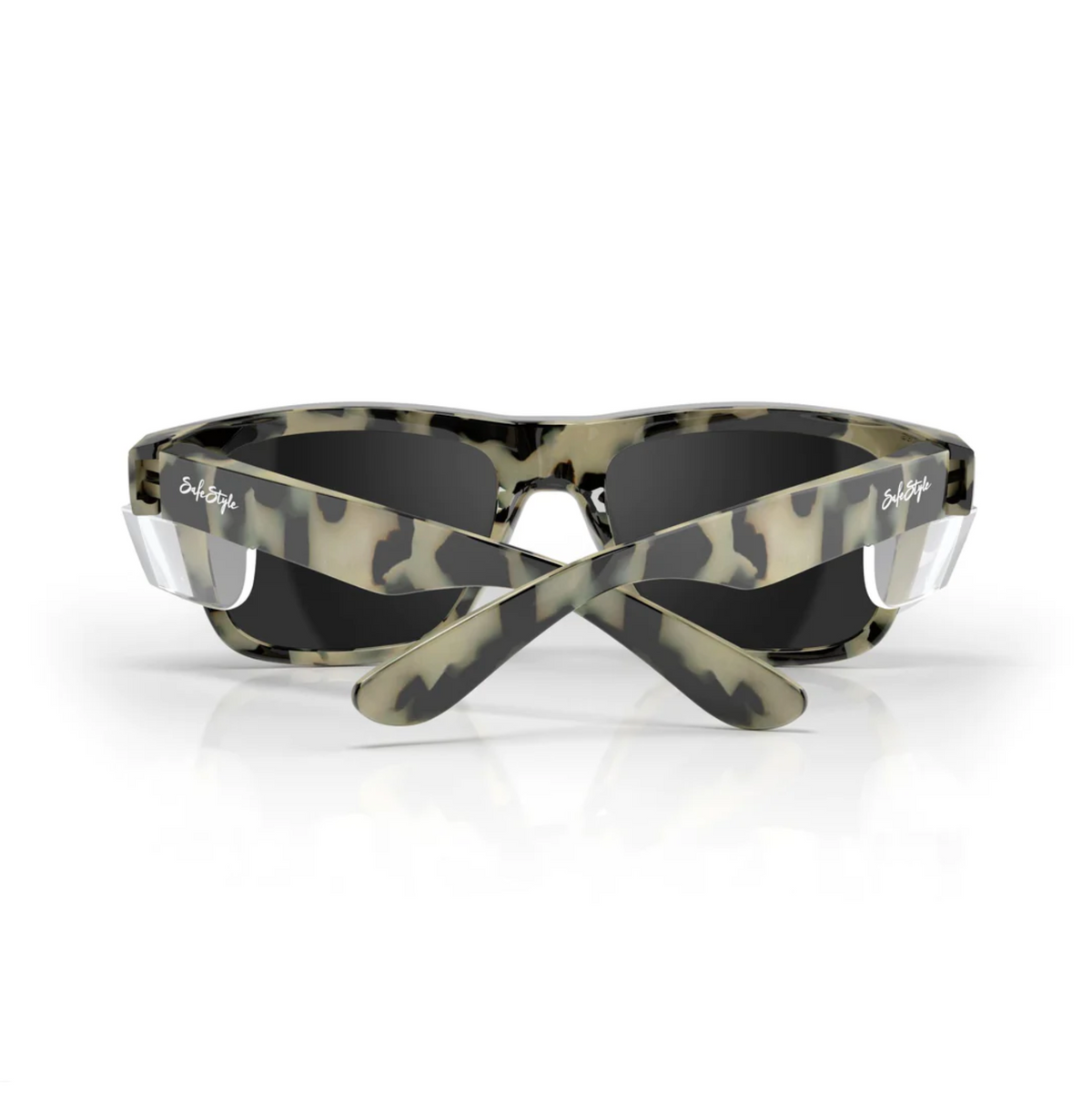 The SafeStyle Fusions sunglasses have a Milky Tort frame with the brand logo on the arms and dark, polarized lenses for UV protection. The crossed arms showcase their unique style against a plain white background.