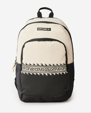 The Rip Curl Ozone 2.0 30L Backpack, made from recycled polyester, features a Greek key pattern on the beige and black front pocket with a top black "Rip Curl" logo. It has a black handle, side pockets, a classic rounded shape, and a laptop section for convenient storage.