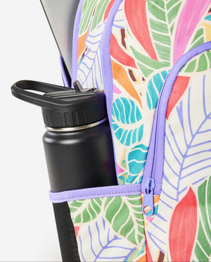 The Rip Curl Ozone 2.0 30L Backpack, made from recycled polyester, features a leaf pattern with purple trim, a small rainbow zipper pull, a laptop section, and has a black water bottle in its side pocket.