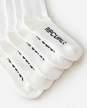 Five pairs of white ribbed Rip Curl School Crew Socks are stacked diagonally, each with "RIP CURL" in black on the toes. The socks feature arch support and a terry footbed for comfort, shown on a plain white background.