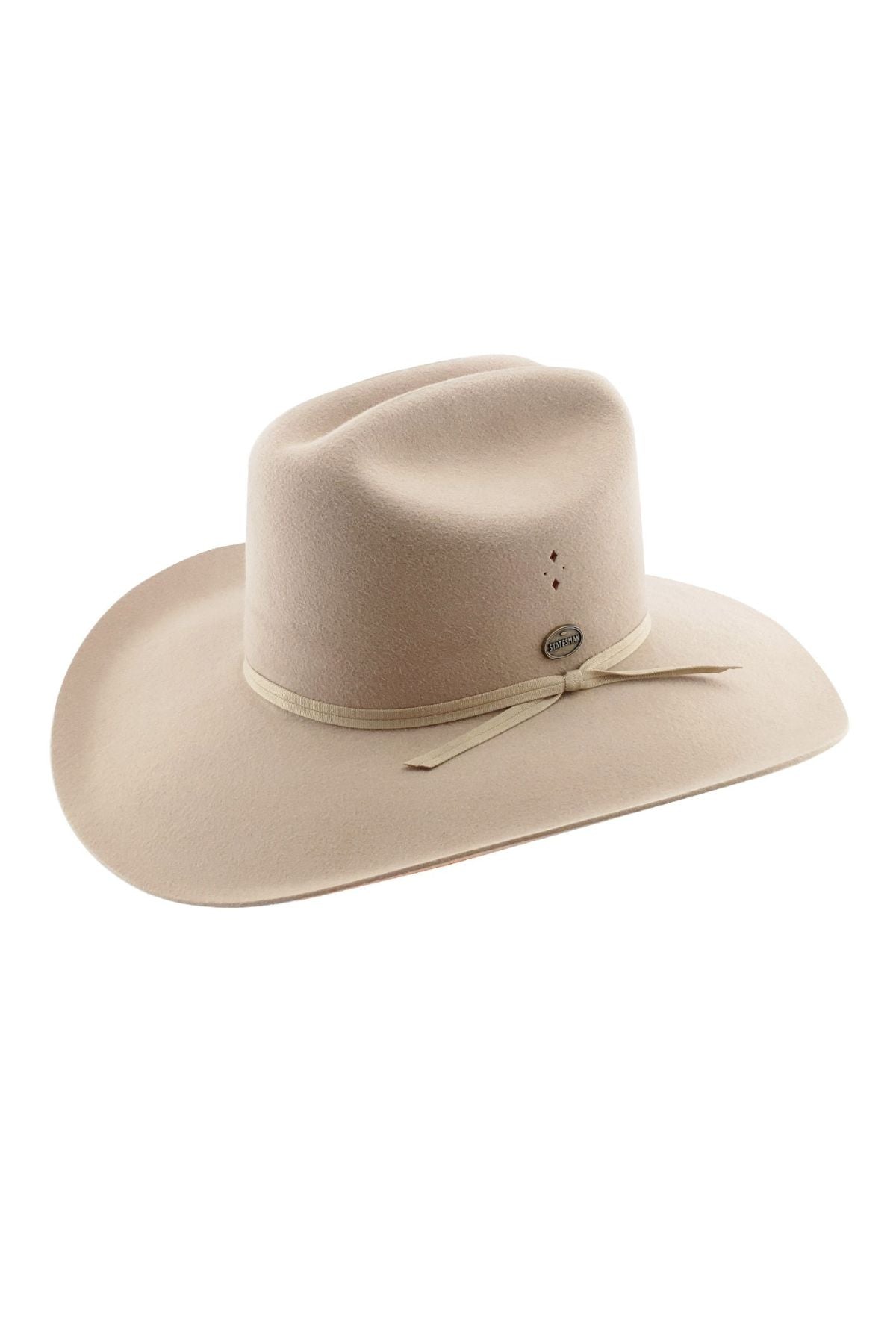The Statesman Serpentine Fur Felt Hat is a beige cowboy hat made from rabbit fur felt. It has a wide brim, a ribbon band with small ventilation holes on the front, and a subtle decorative pin. The crown is creased in cattleman style for classic flair.